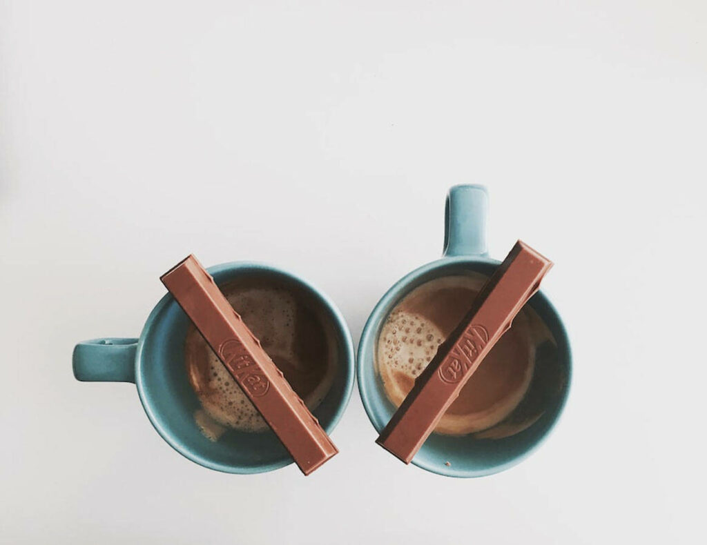 Twin Mugs of Warm Hot Chocolate Topped with Crispy Kit Kat Treats Captured from Above Wallpaper