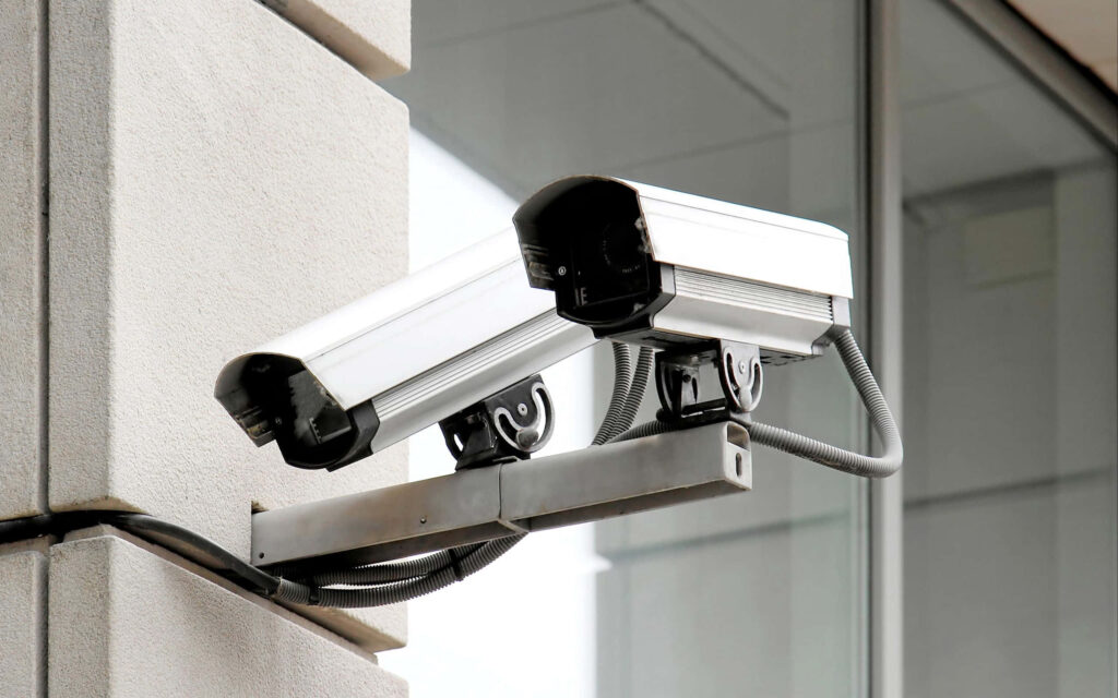 Double Vision: Captivating Wallpaper of Twin Varifocal Bullet Security Cameras in Black and White