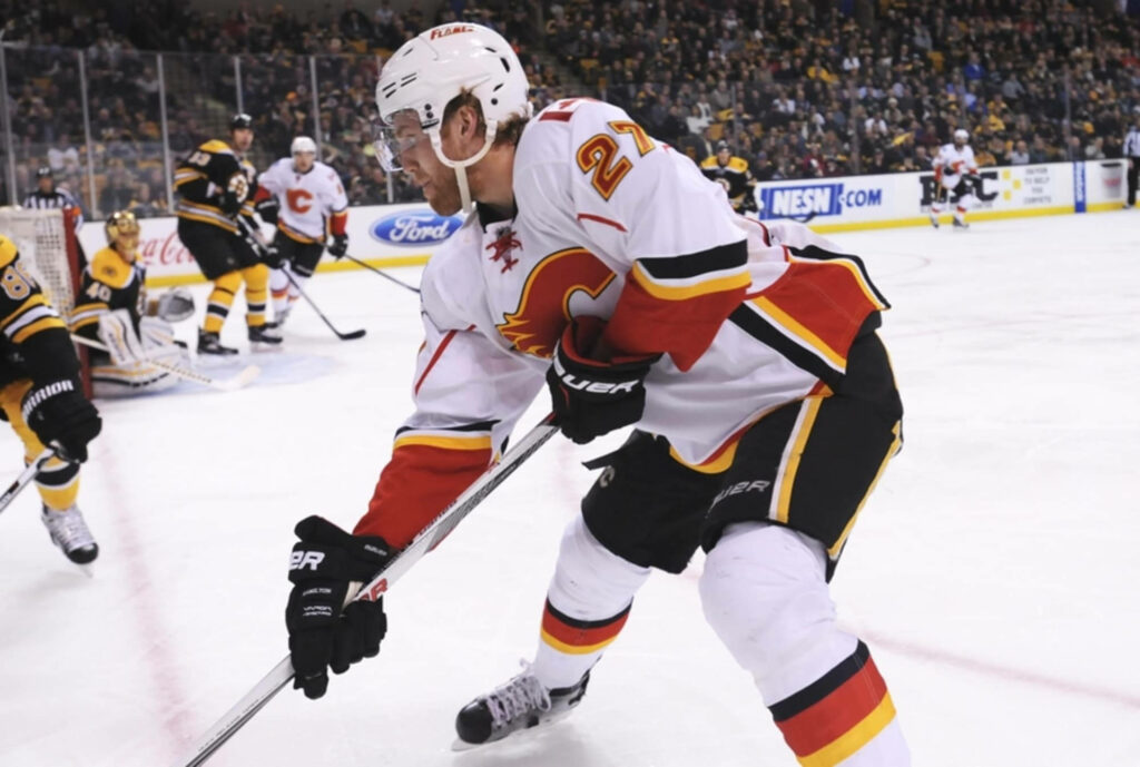 Dougie Hamilton Calgary Flames intense action 2016 game vibrant hockey stadium background Wallpaper