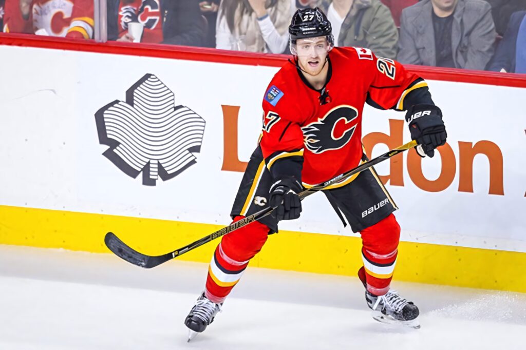 Dougie Hamilton Calgary Flames in action on ice versus Vancouver Canucks NHL hockey intense play Wallpaper