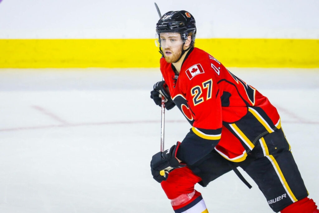 Dougie Hamilton Calgary Flames in red jersey intense hockey action against Florida Panthers arena Wallpaper