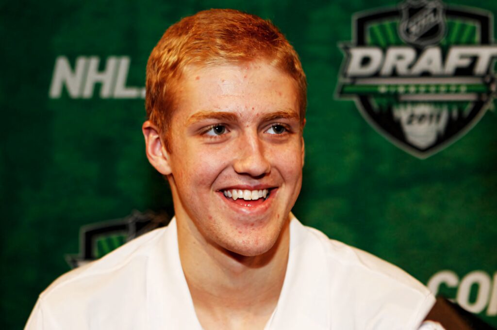 Dougie Hamilton smiling during NHL Entry Draft interview with vibrant green NHL Draft logo backdrop Wallpaper