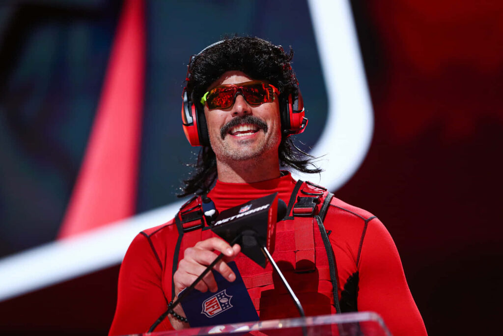 Dr DisRespect wallpaper with red vest mullet wig reflective sunglasses bold gaming background