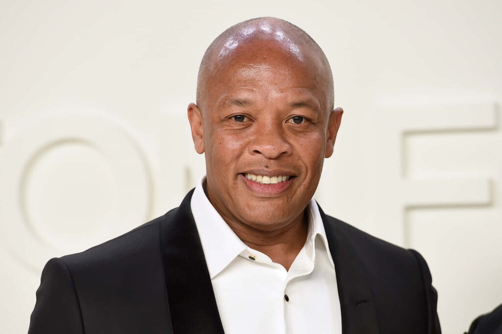 Dr. Dre in a Suit: Confident Iconic Rapper Wallpaper Background