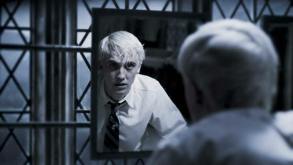 Draco Malfoy anxious stare in mirror dark blue tones gothic window Harry Potter wallpaper background