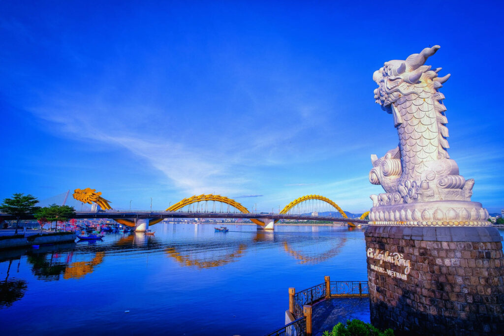 Dragon Carp statue overlooking Dragon Bridge in Da Nang Vietnam vibrant riverside wallpaper