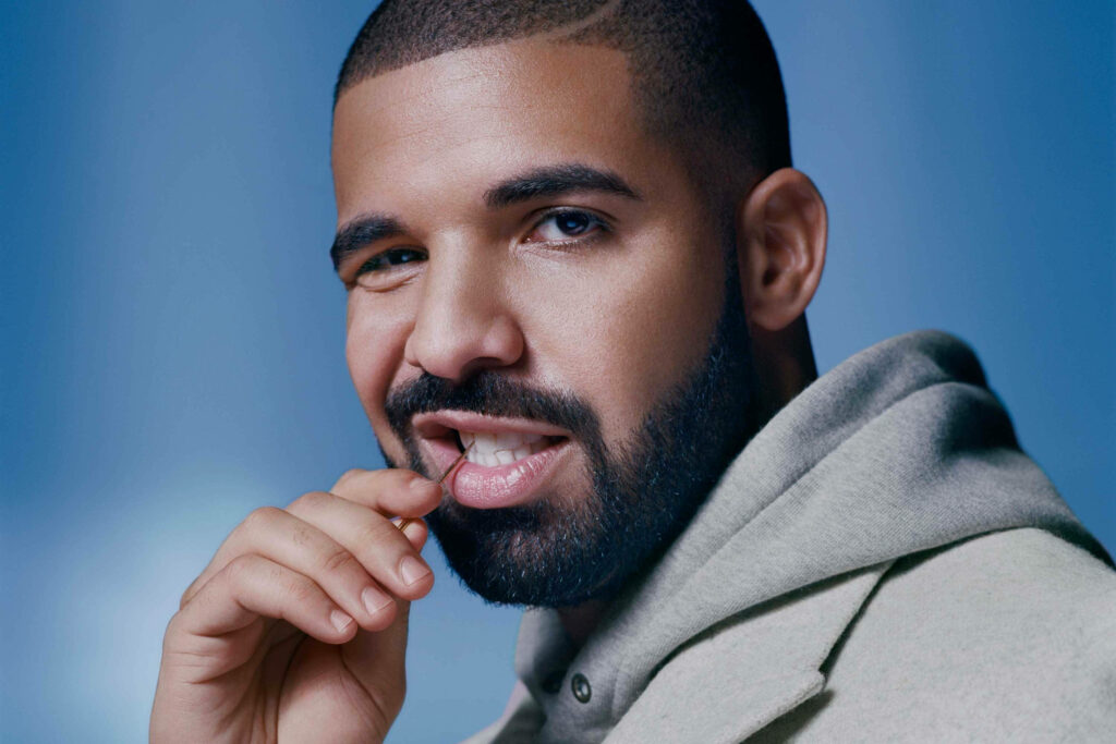 Drake Close-Up Wallpaper: Charismatic Style on Soft Blue Background