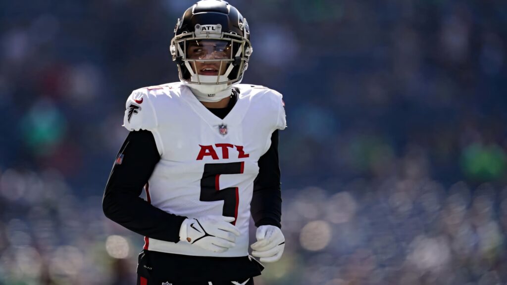 Drake London Atlanta Falcons in white and black uniform focused under sunlit stadium game day Wallpaper