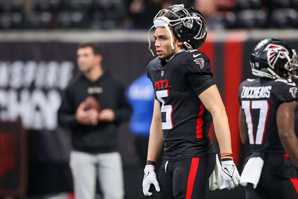 Drake London Atlanta Falcons focused on field wearing black red uniform during intense NFL game Wallpaper