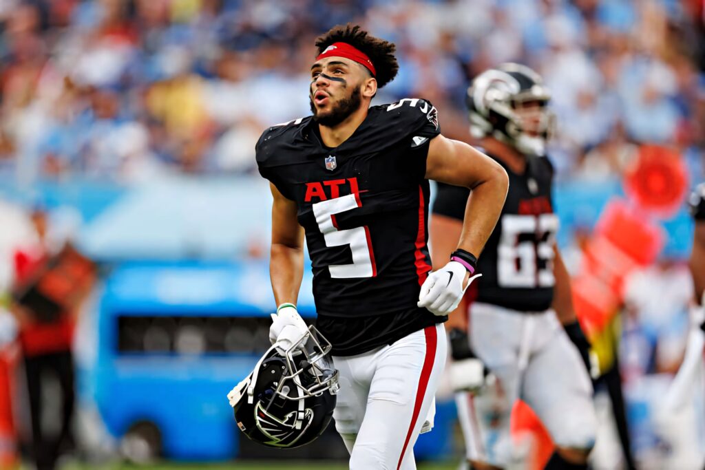 Drake London Atlanta Falcons number 5 in black red uniform intense game day action stadium background Wallpaper