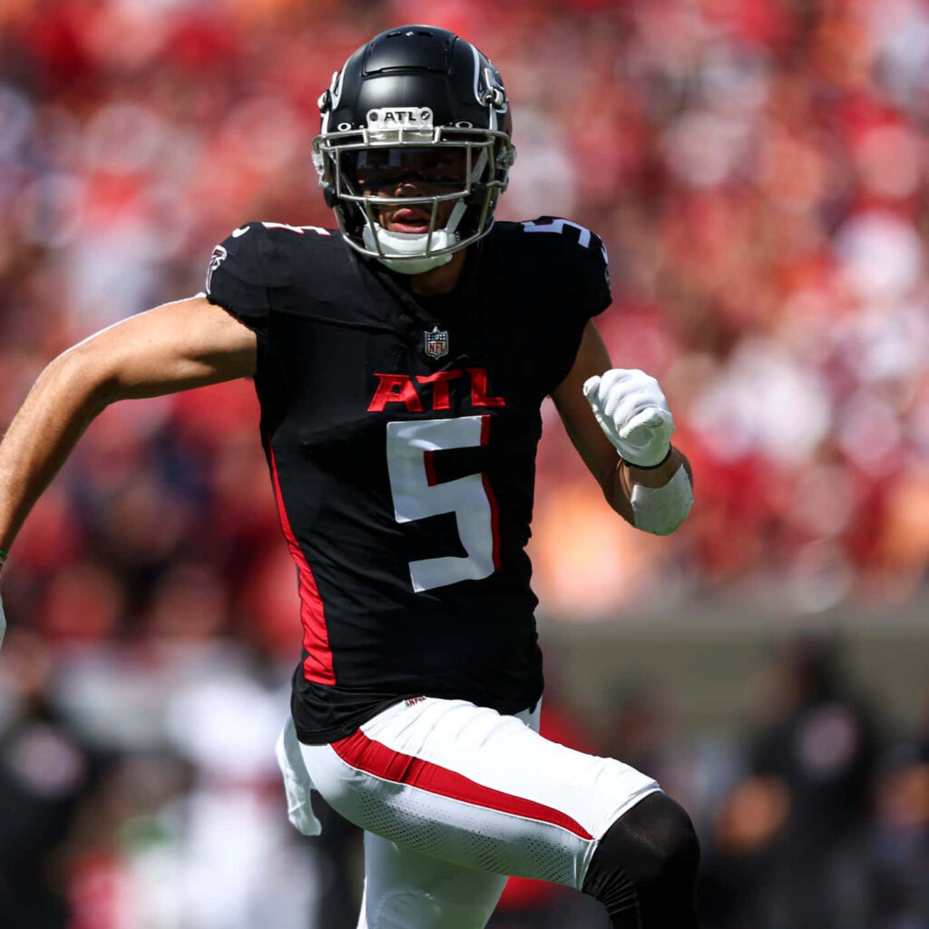 Drake London Atlanta Falcons wide receiver number 5 action shot vibrant red stadium background Wallpaper