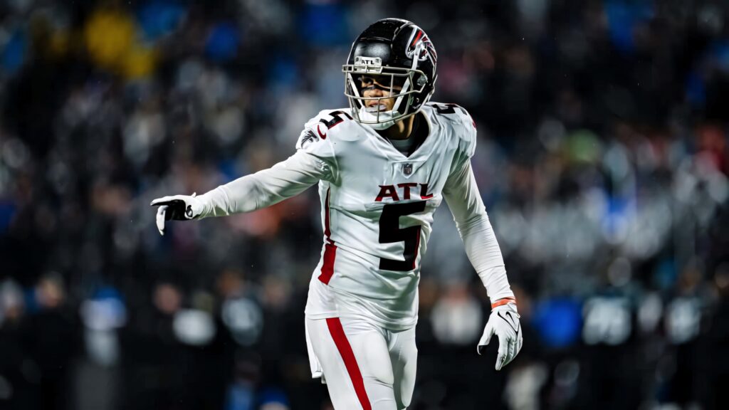 Drake London Atlanta Falcons in white uniform mid-action intense focus football game background Wallpaper