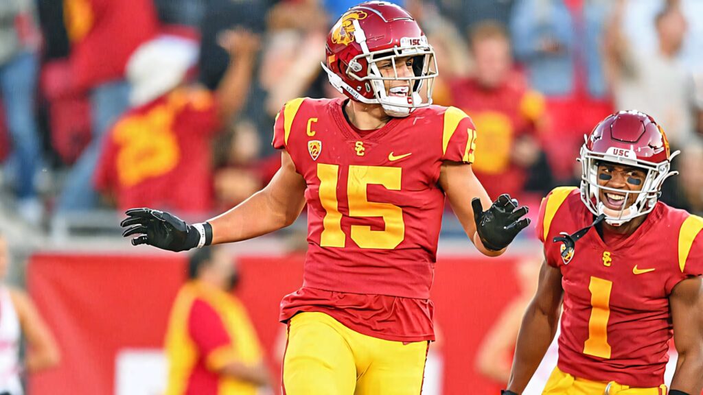 Drake London in USC cardinal and gold uniform mid-action during vibrant college football game Wallpaper