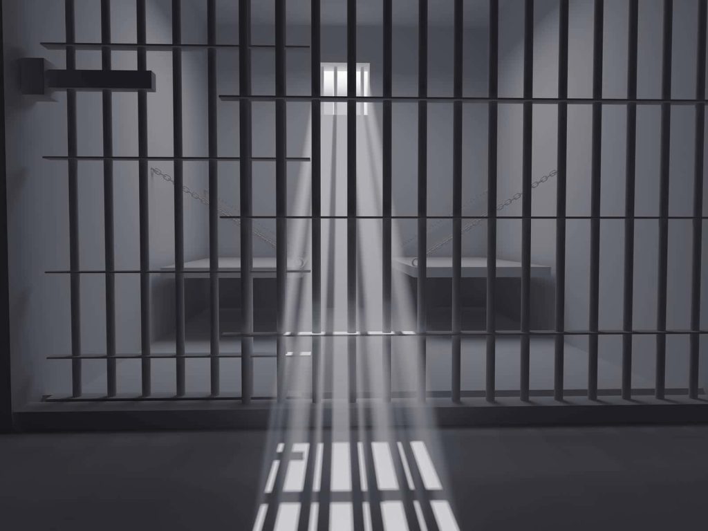 3D digital art of a prison cell with iron bars and light beam highlighting dark moody isolation Wallpaper