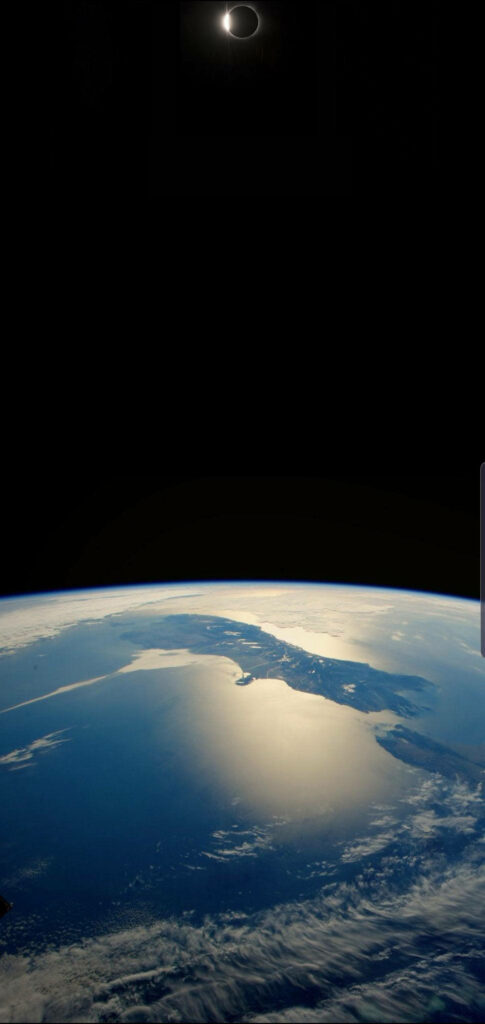 4K solar eclipse phone wallpaper with sun corona glowing above Earth blue hues in deep space