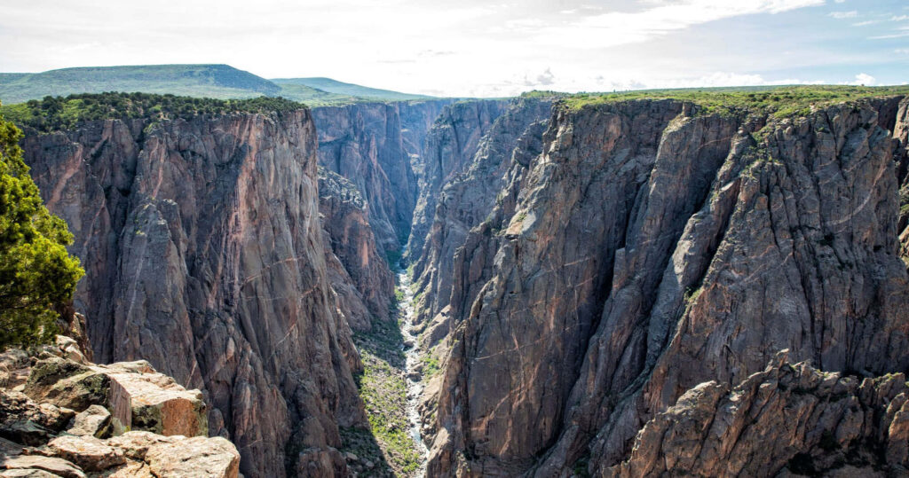 Black Canyon steep rugged cliffs with deep shadows showcasing dramatic canyon depth wallpaper