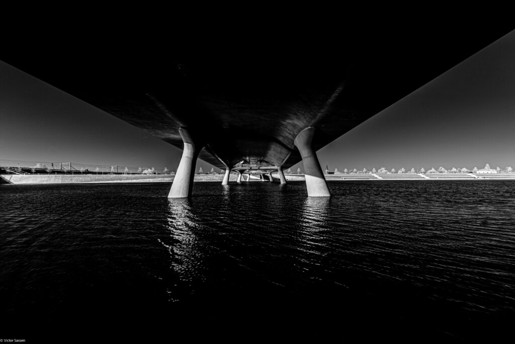 Striking Black and White Bridge Wallpaper: Reflective River View