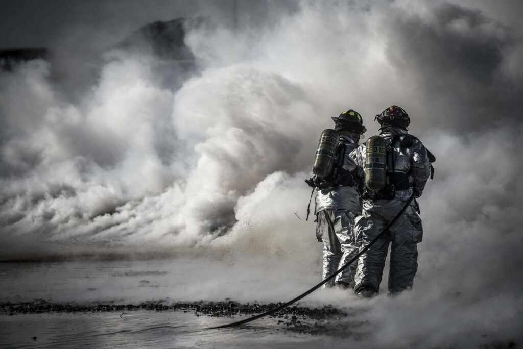 Dynamic Black and White Firefighters Wallpaper with Dramatic Smoke