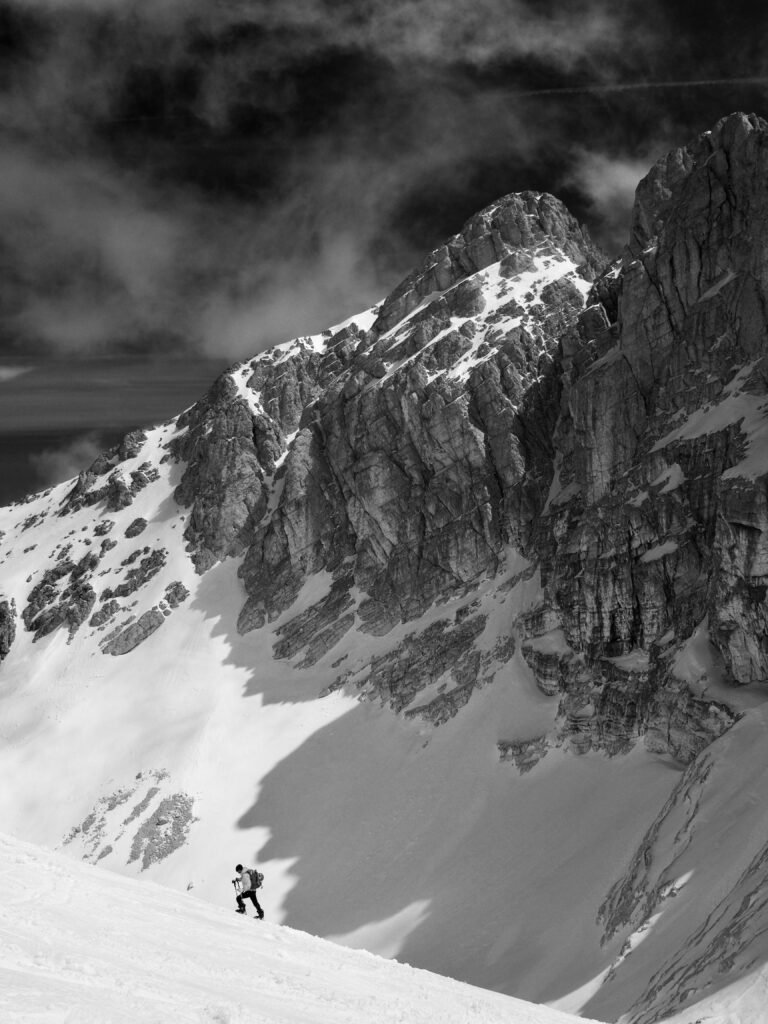 Dramatic Black and White Mountain Wallpaper with Lone Climber