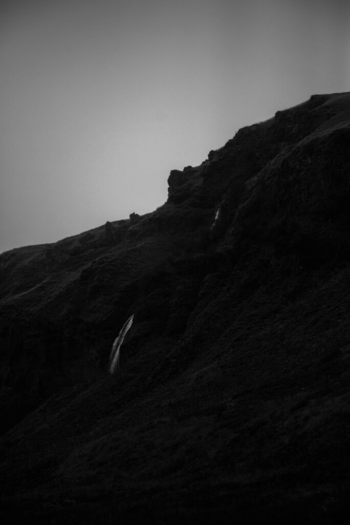 Moody Black and White Mountain Wallpaper with Cascading Waterfall