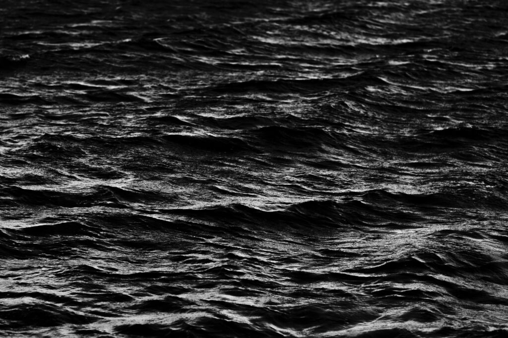 Black and white ocean waves wallpaper highlighting texture movement and dramatic water flow