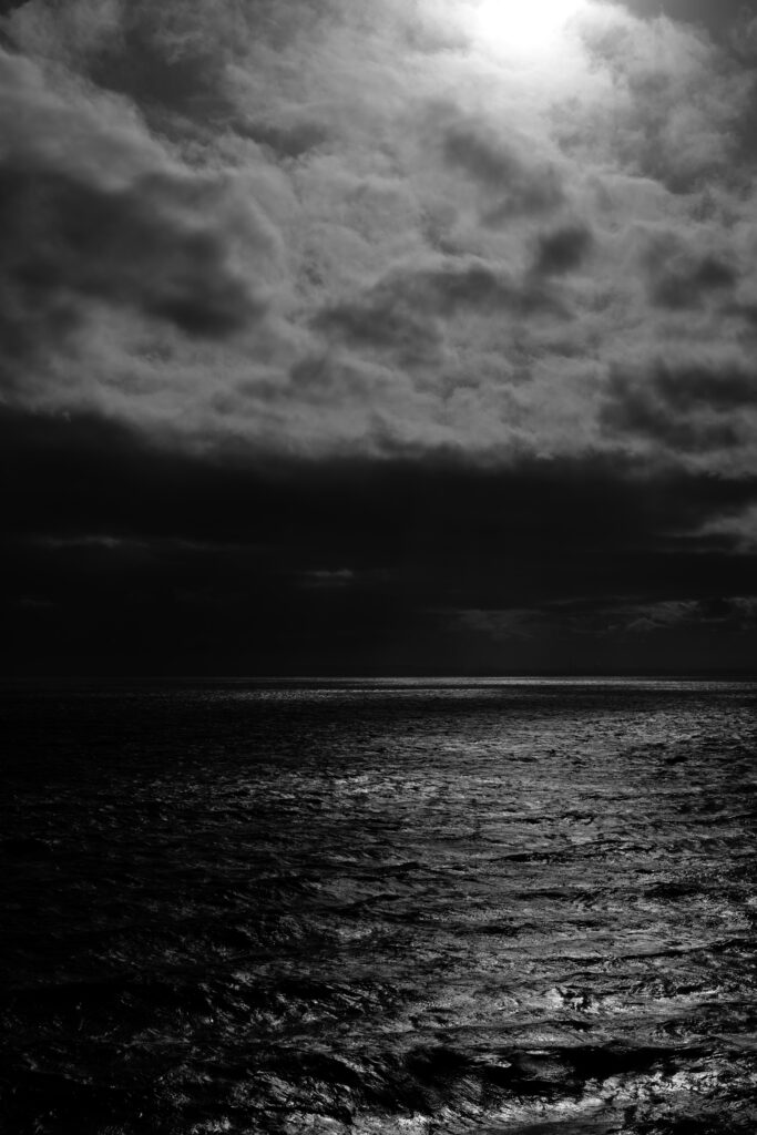 Striking Black-and-White Seascape Wallpaper with Dramatic Clouds