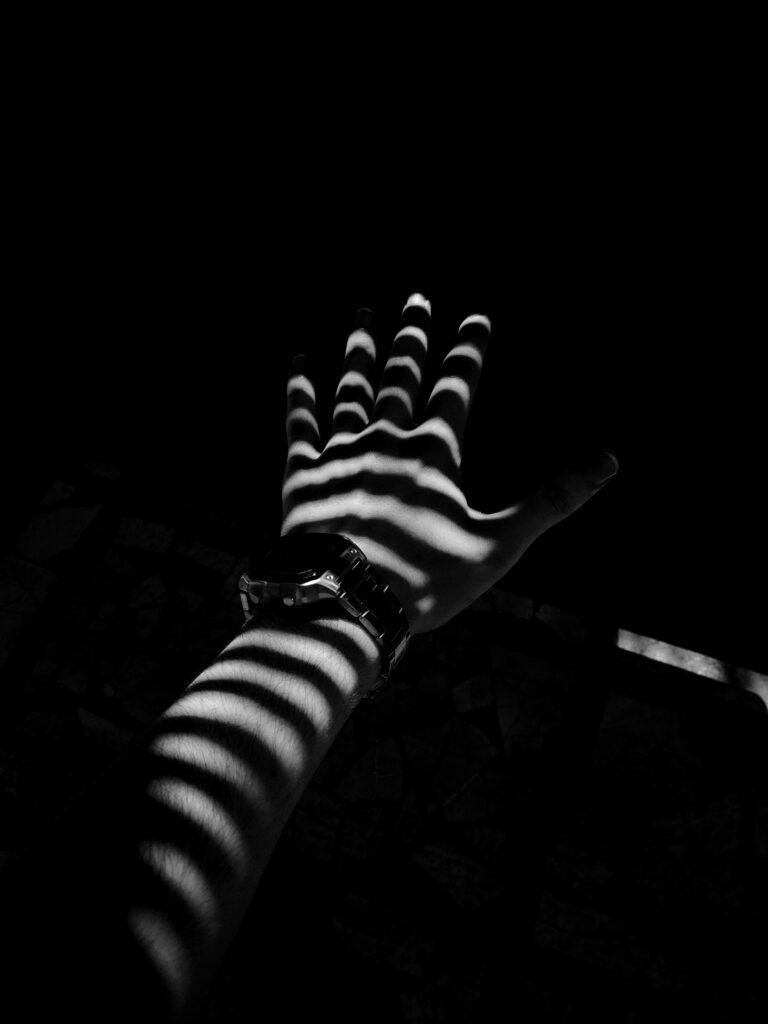 Striking Black & White Wallpaper: Hand with Watch & Shadows