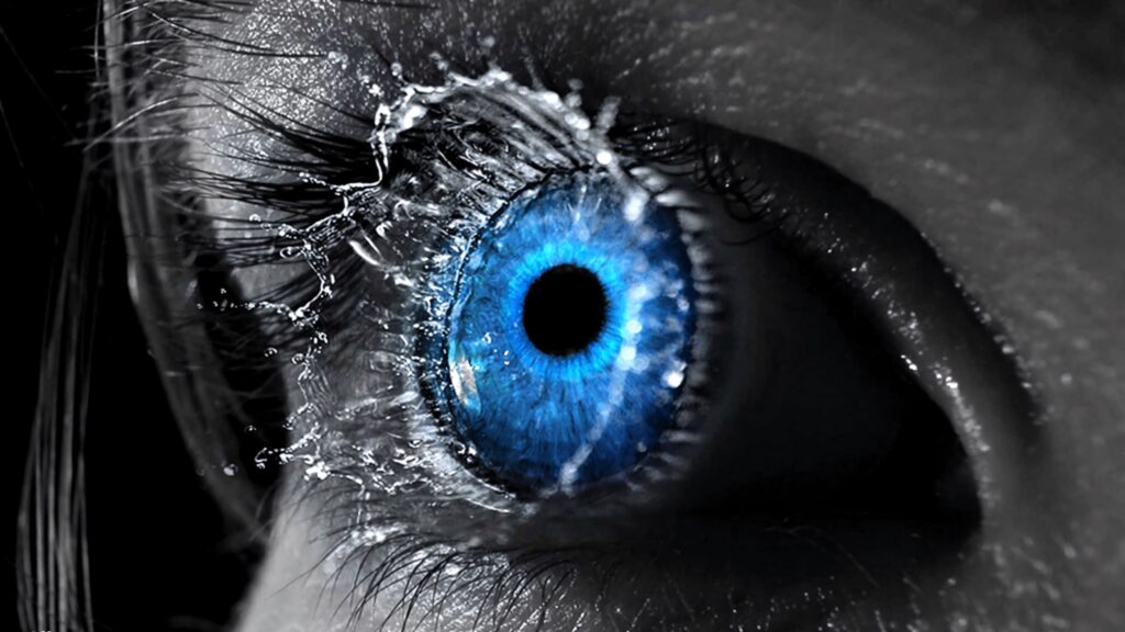 Closeup of blue eye with detailed textures and bursting tears like water splashes wallpaper background