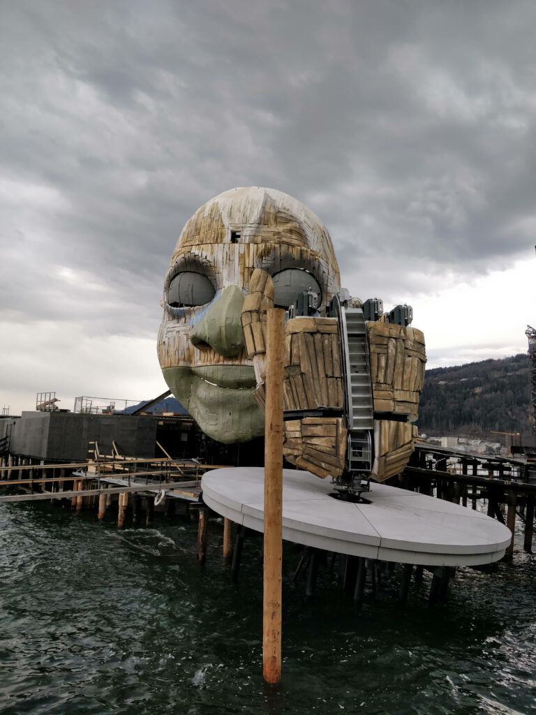 Dramatic Bregenz Festival stage Austria giant sculpted face cloudy skies Lake Constance view Wallpaper