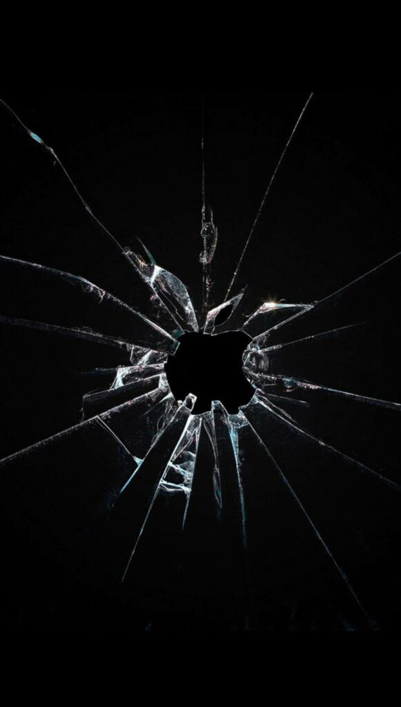 Reflective broken glass wallpaper with dramatic central impact and jagged cracks on black background