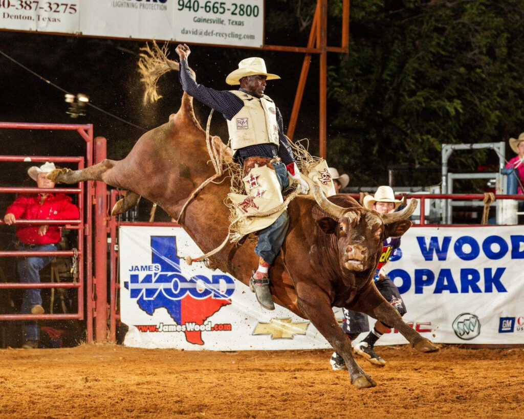 Cowboy mid bull ride rodeo wallpaper dynamic motion vivid earth tones authentic western gear