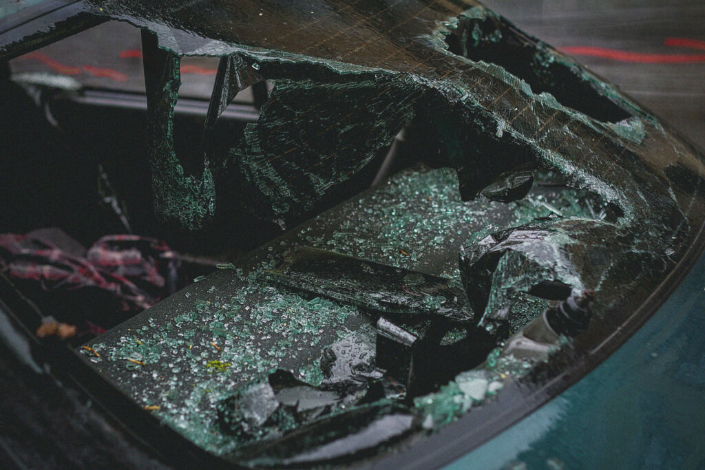 Dramatic car accident wallpaper shattered windshield broken glass intense urban lighting background