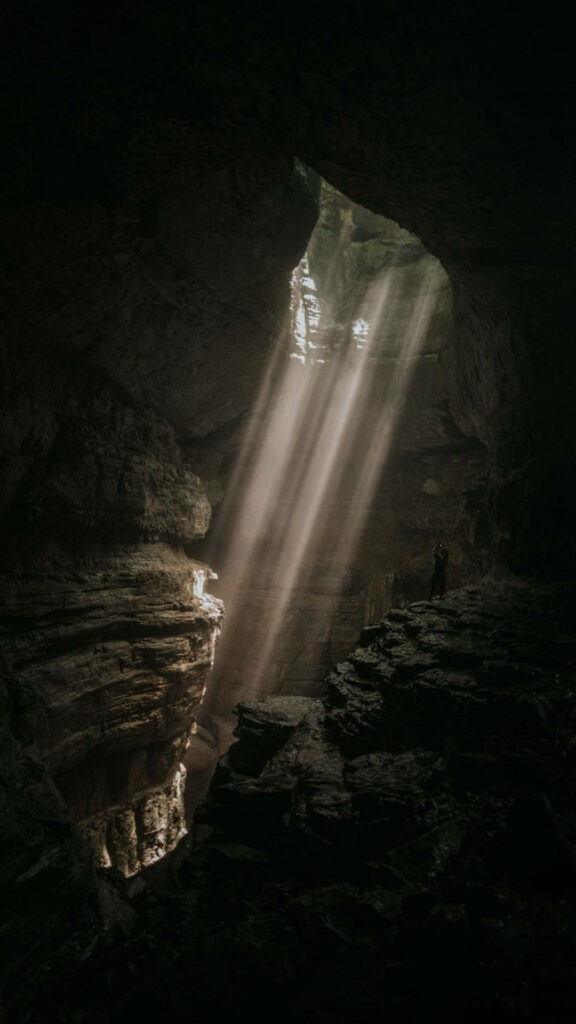 Serene Cave Wallpaper: Sunlight Streams in for a Mystical Atmosphere