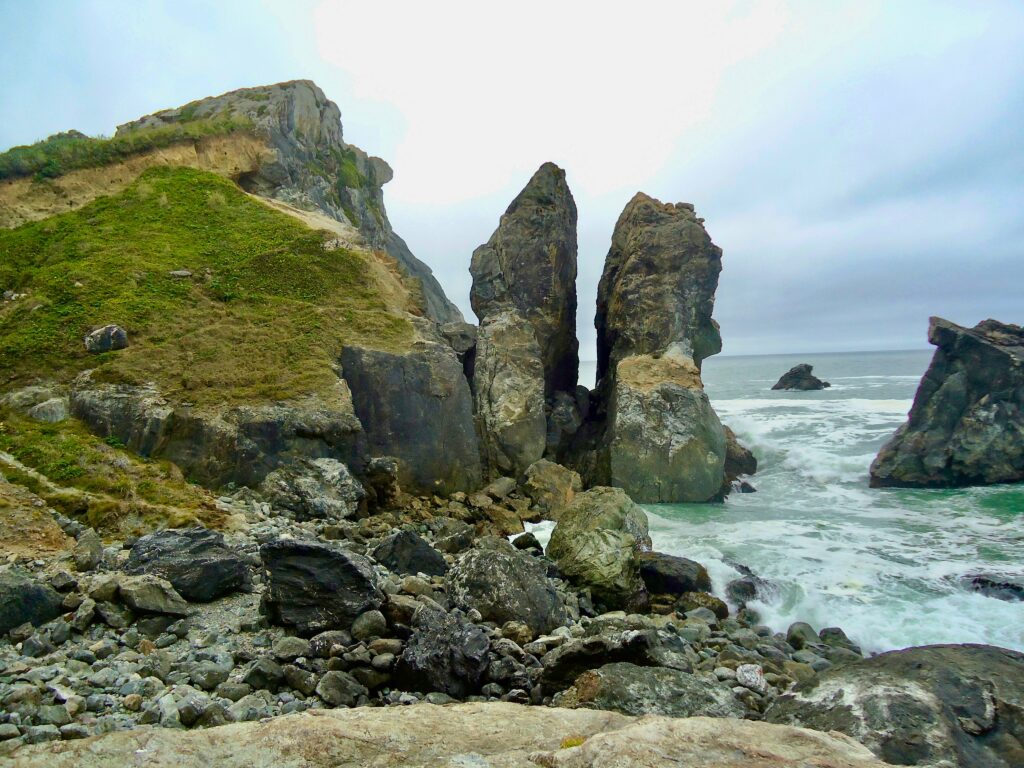 Dramatic coastal cliffs with lush greenery foaming ocean waves and stormy sky wallpaper background