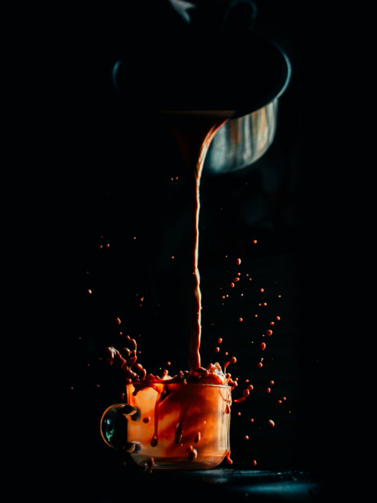 Artistic Coffee Splash Wallpaper: Dynamic Drink Pour on Dark Background