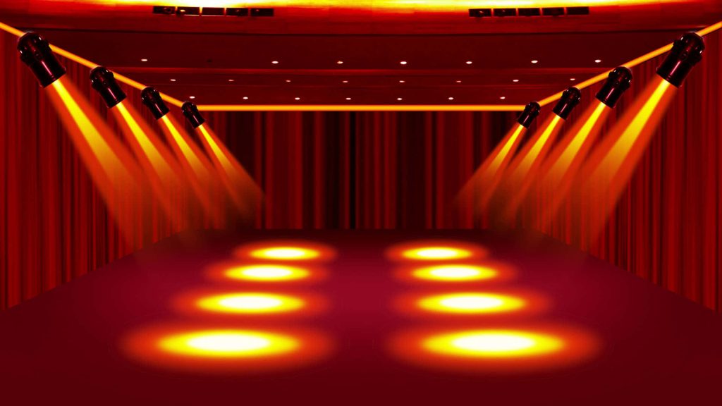 Empty stage with deep red curtains and vibrant yellow-orange spotlights concert background wallpaper