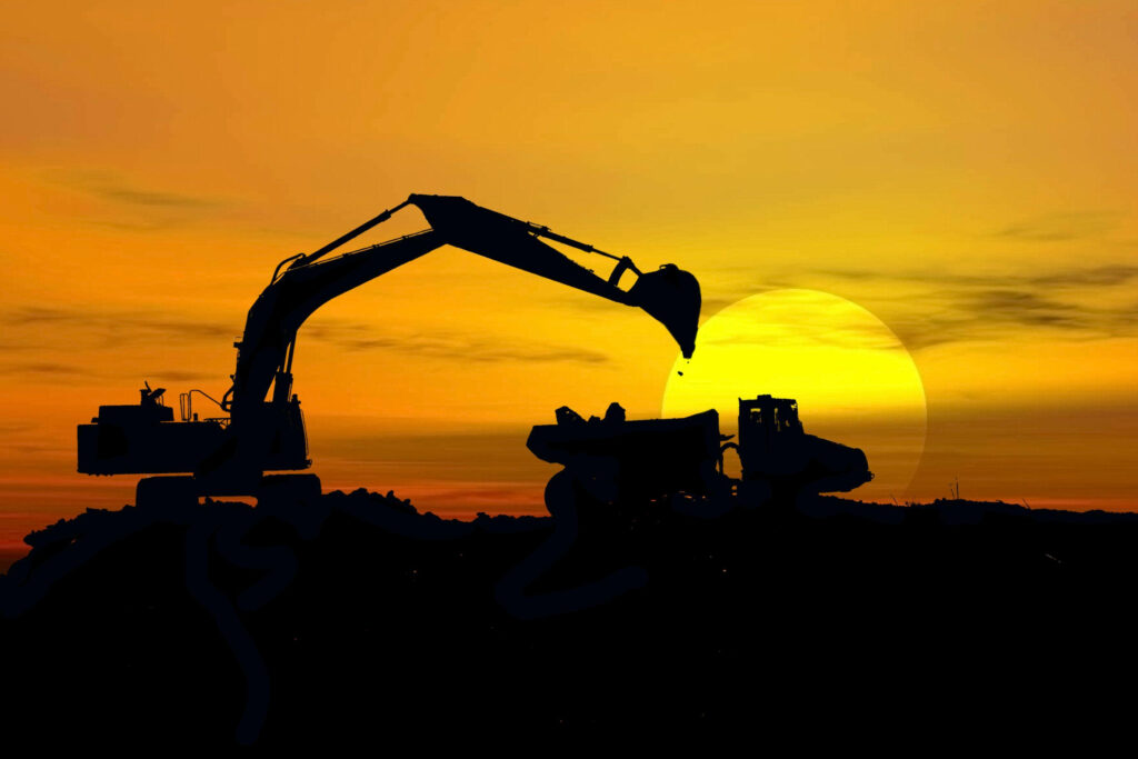 Silhouette of construction equipment at sunset highlighting civil engineering infrastructure development Wallpaper