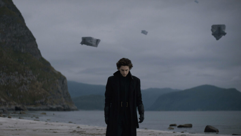 Paul Atreides on Shoreline: Dramatic Dune Wallpaper Background