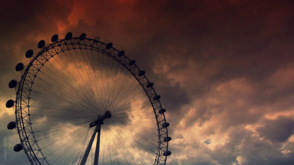 Dramatic Ferris Wheel Wallpaper: Moody Sky & Cinematic Atmosphere