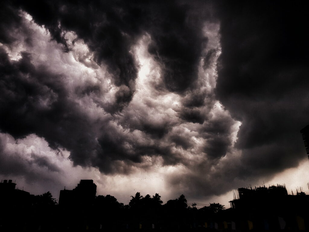 Dramatic HD Wallpaper: Ominous Cloudy Sky Over Silhouetted Cityscape