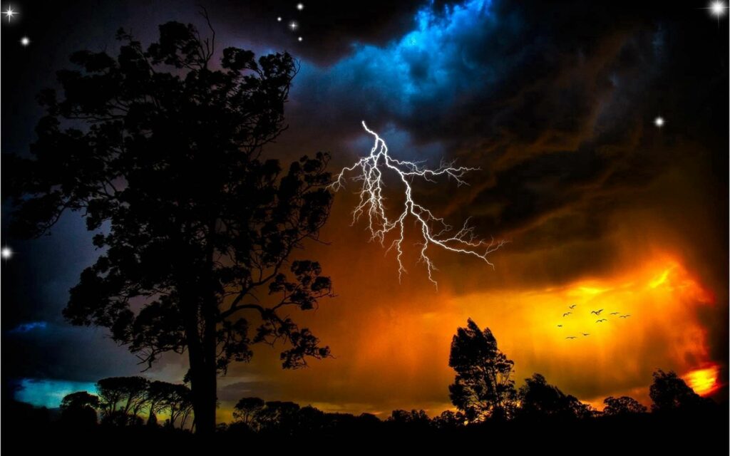 Dramatic night sky wallpaper vivid lightning dark clouds silhouetted trees orange blue hues stars birds