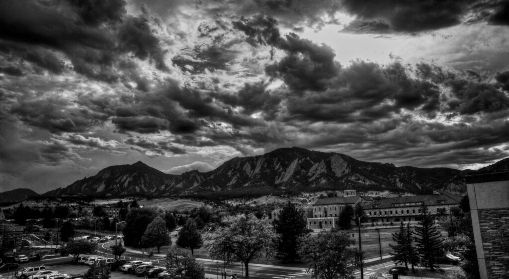 Dramatic Monochrome Mountain Landscape with Turbulent Sky Background Wallpaper