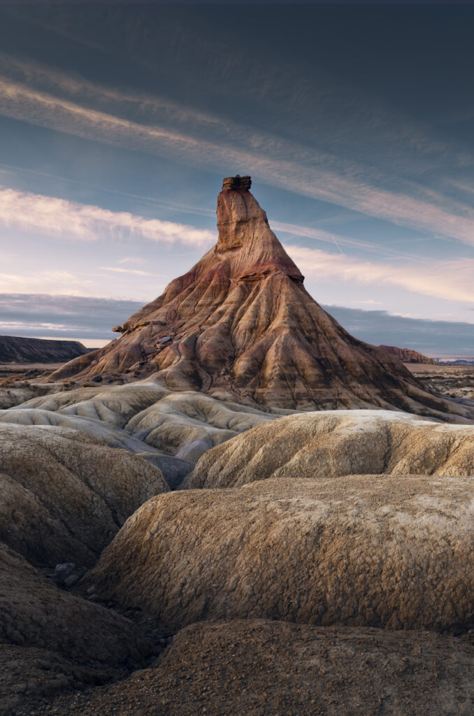 Striking mountain formation with earthy rocky landscape under moody cloudy sky wallpaper background