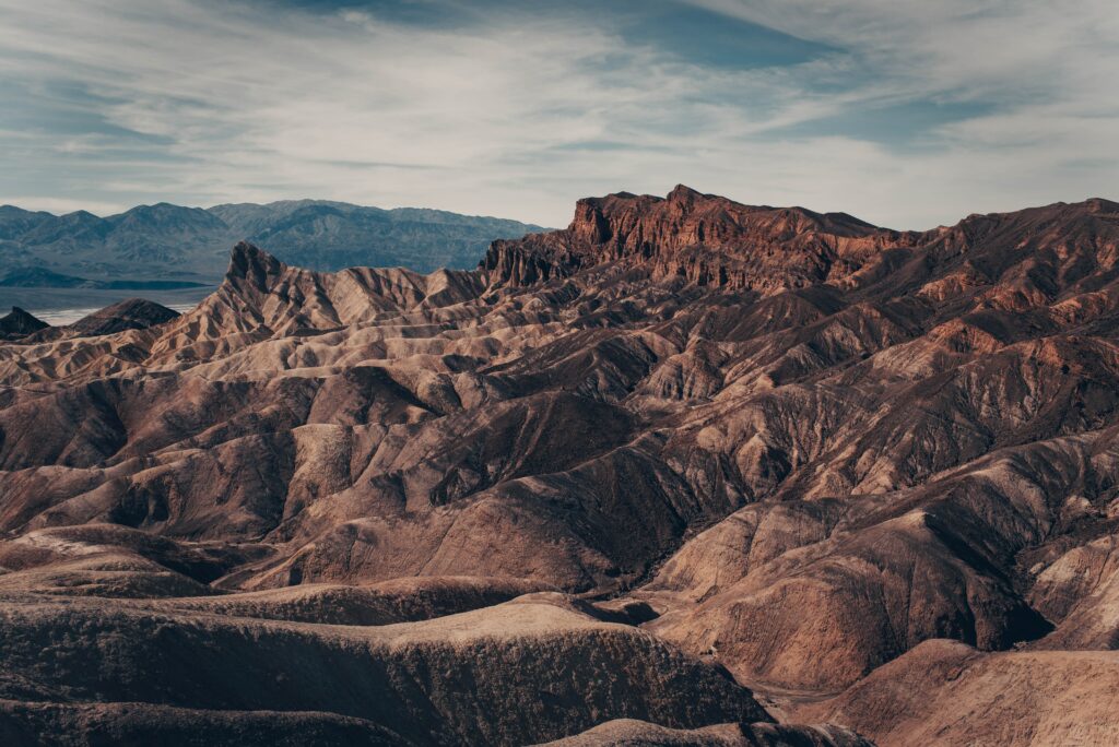 Dramatic mountain landscape with rugged hills and moody sky in rich earthy tones wallpaper background