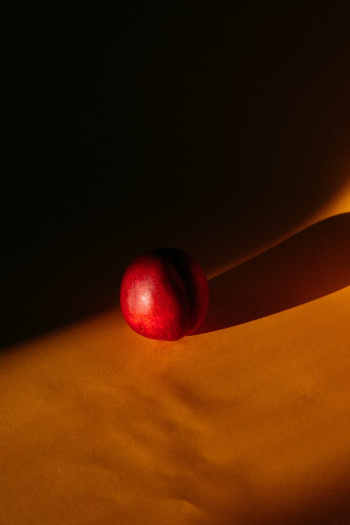 Dramatic Nectarine Wallpaper: Vibrant Fruit on Dark Background