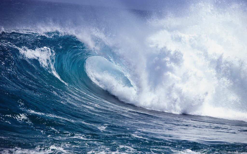 Dramatic ocean wave crashing with deep blue and aqua tones dynamic swirling water texture wallpaper