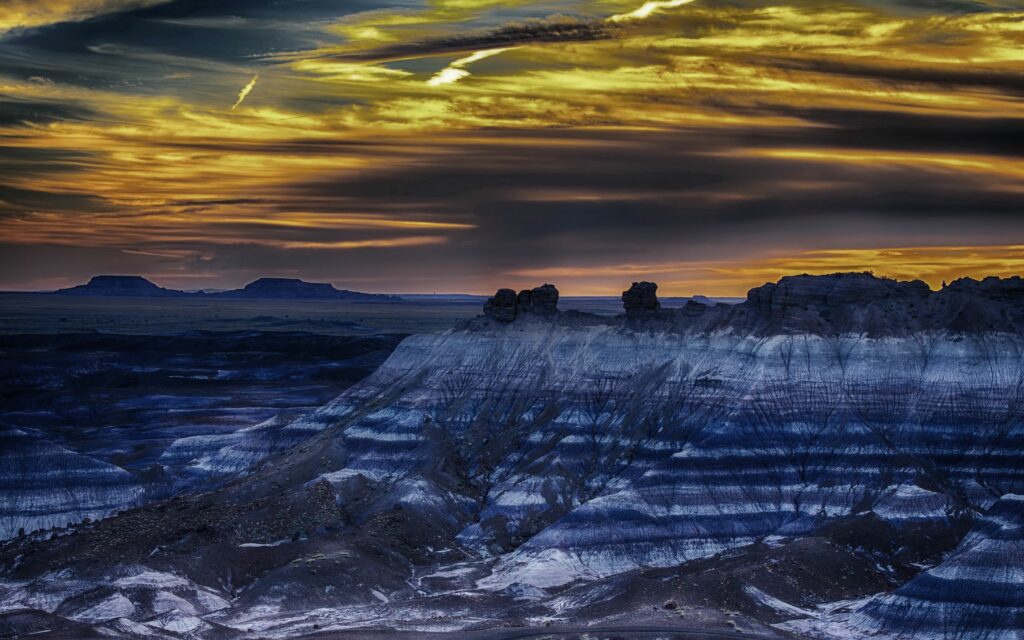 HDR wallpaper of Petrified Forest Arizona rugged mountains striped rocks vibrant golden sunset