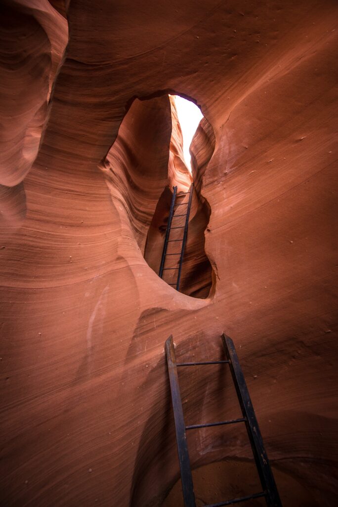 Dramatic canyon wallpaper with warm red stone walls erosion rustic wooden ladder adventure