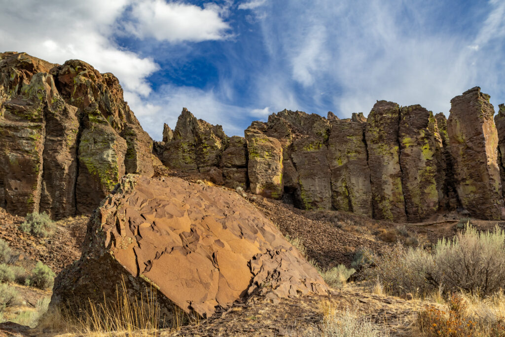 Dramatic rugged mountain landscape with jagged peaks stones and vibrant blue sky wallpaper