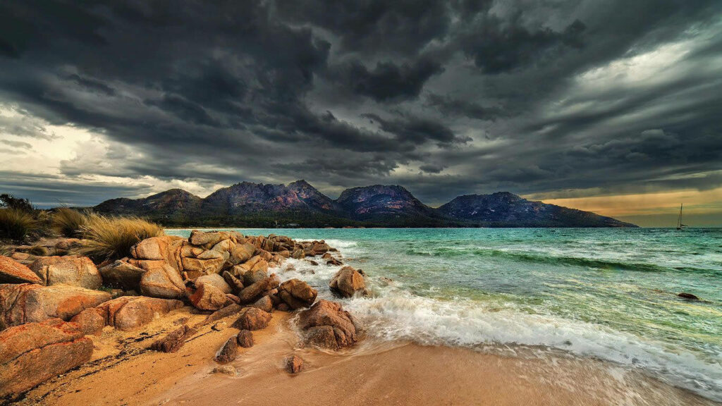 Dramatic Seascape Wallpaper: Rugged Beach & Stormy Sky Background